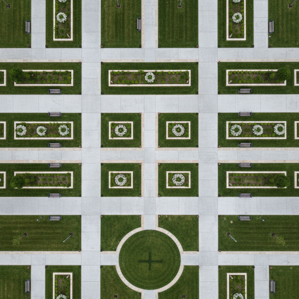 A structured municipal park is captured from above as a high-end drone records comprehensive survey data, its shadow faintly visible on the evenly trimmed grass below. The park features sharply defined walking paths, geometric garden beds, and neatly spaced benches, all outlined in subtle neutral tones. The midday light is neutral and diffuse, producing soft but distinct contrast between turf, pavement, and landscaping. The atmosphere is quiet, purposeful, and analytical, highlighting the value of precise aerial oversight for municipal projects. The composition uses a grid-like division of space, with emphasis on symmetry and sharp detail throughout. The style is clean and photographic, reinforcing the site’s focus on accuracy and structured, professional results.